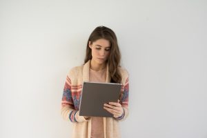 female standing with tablet looking for an EMDR Therapist